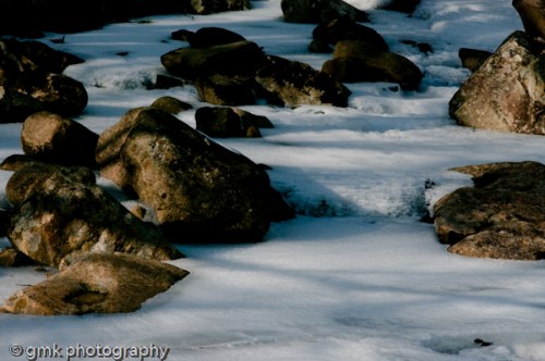 Rocks, suspended in silence, yet singing their winter song